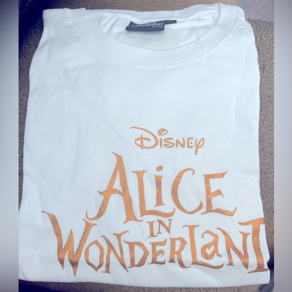 Alice In Wonderland White T-Shirt with Gold lettering.